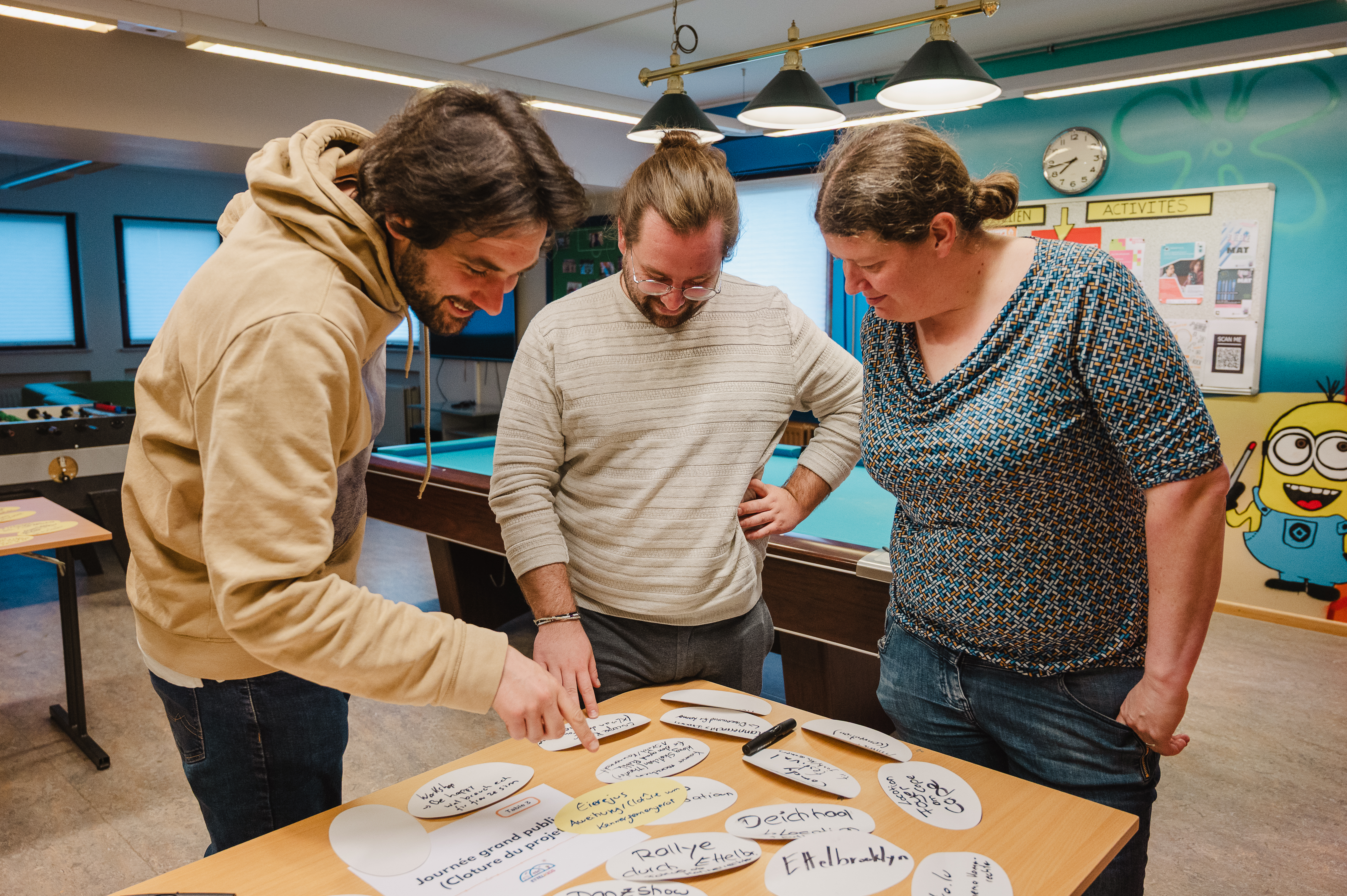 2 men and 1 woman working together as volunteers