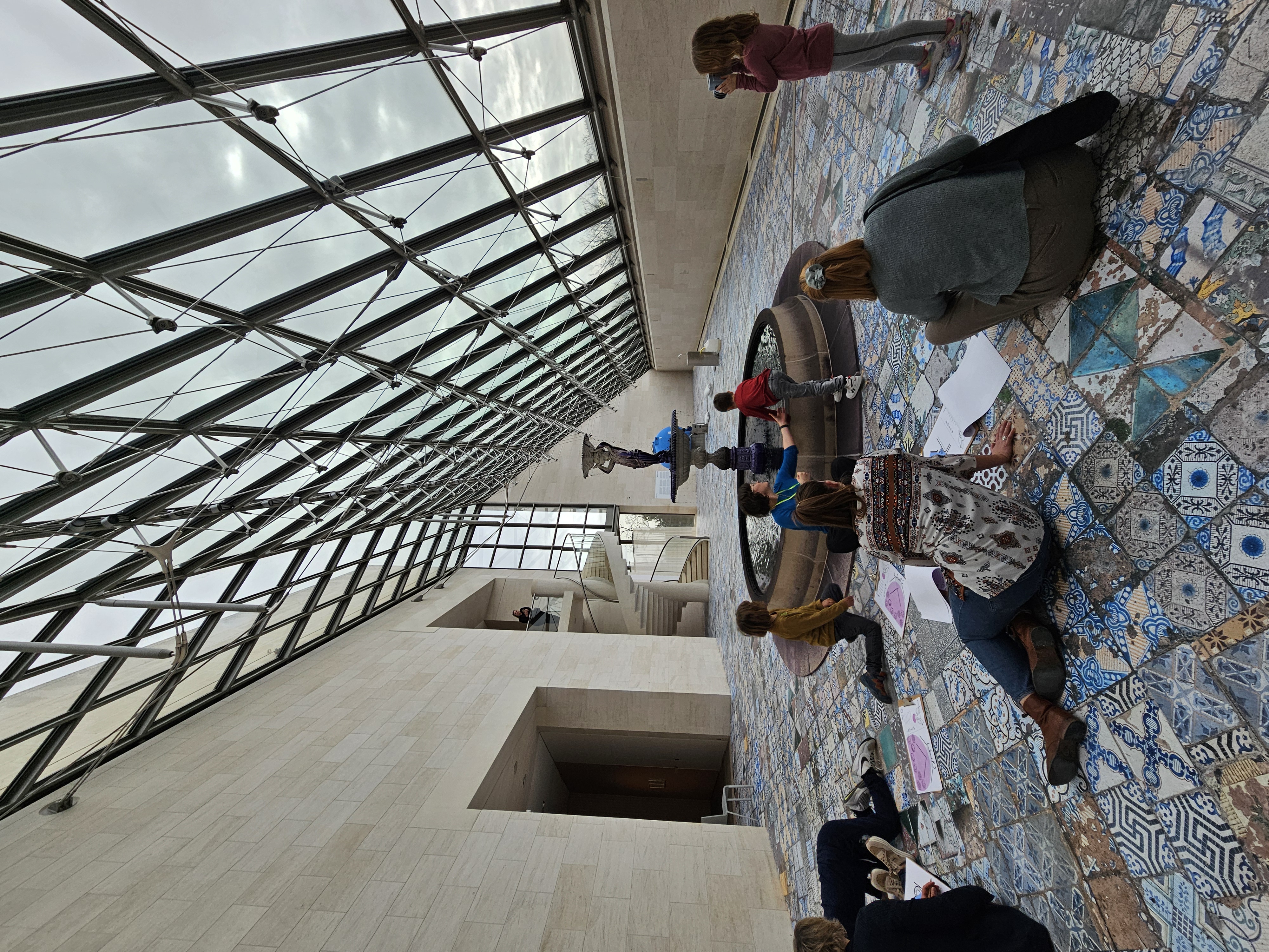 Kids examining a fountain inside a building