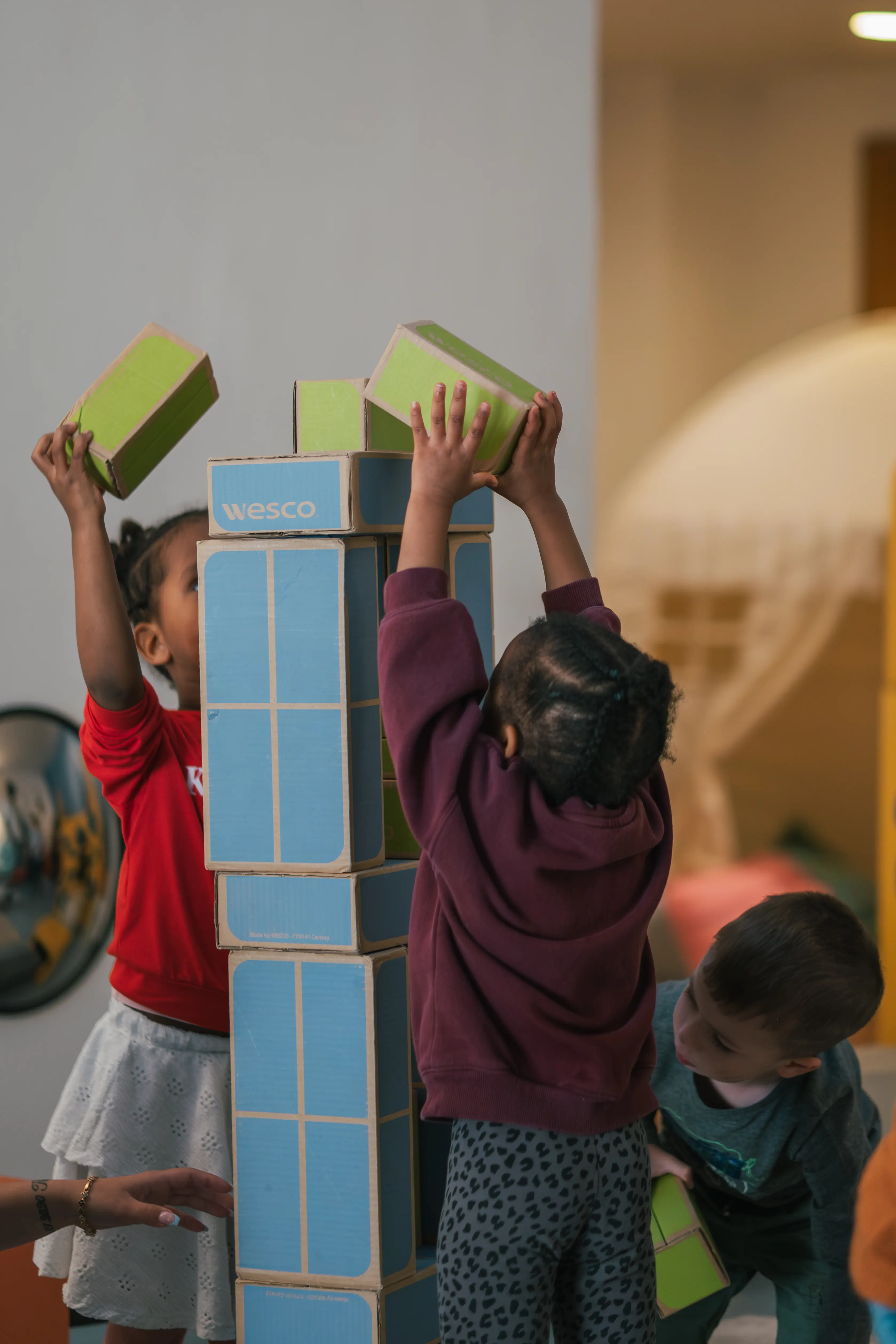 Kids examining a fountain inside a building